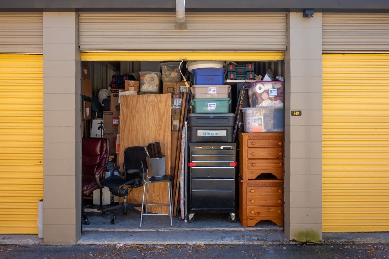 An open storage unit filled with various items, showcasing a cluttered interior.