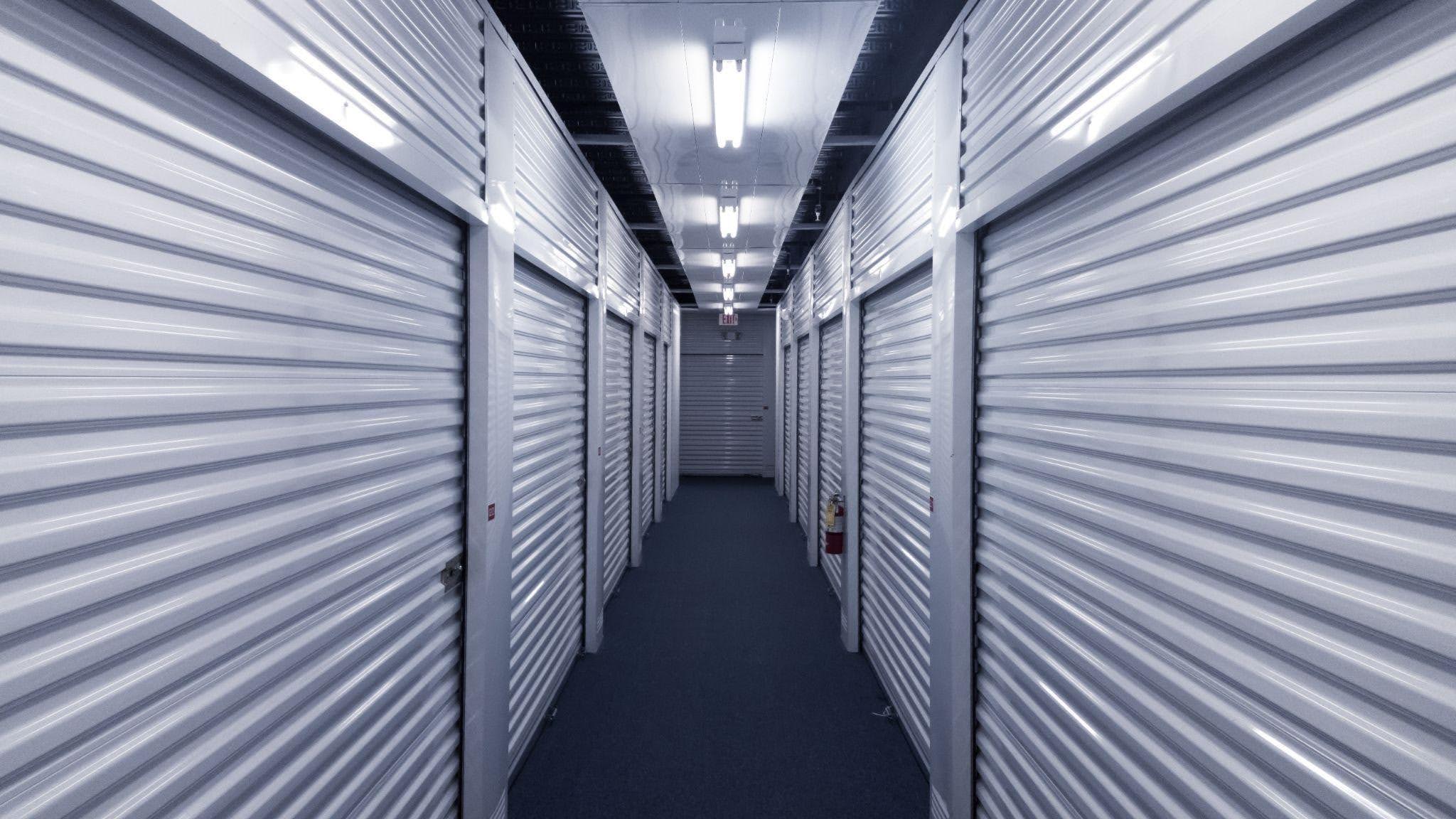 A long hallway featuring white storage units on either side creating a clean and organized environment